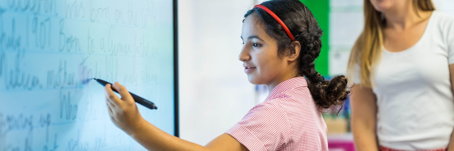 girl writing on a smart board