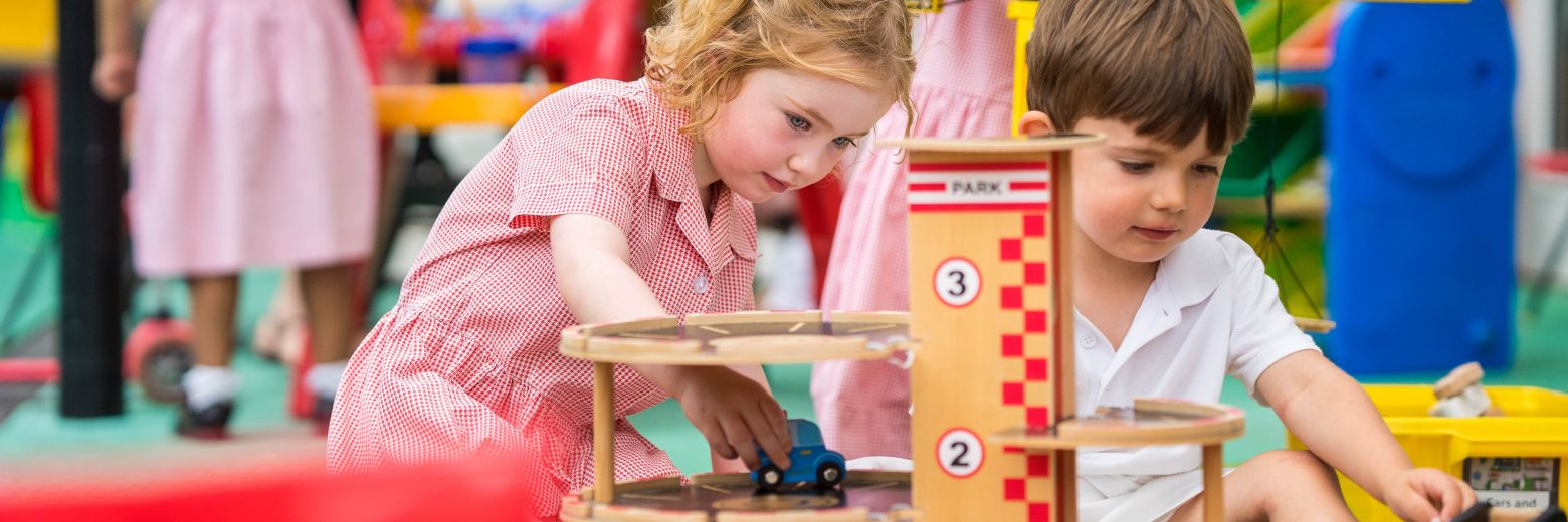 Students playing with cars