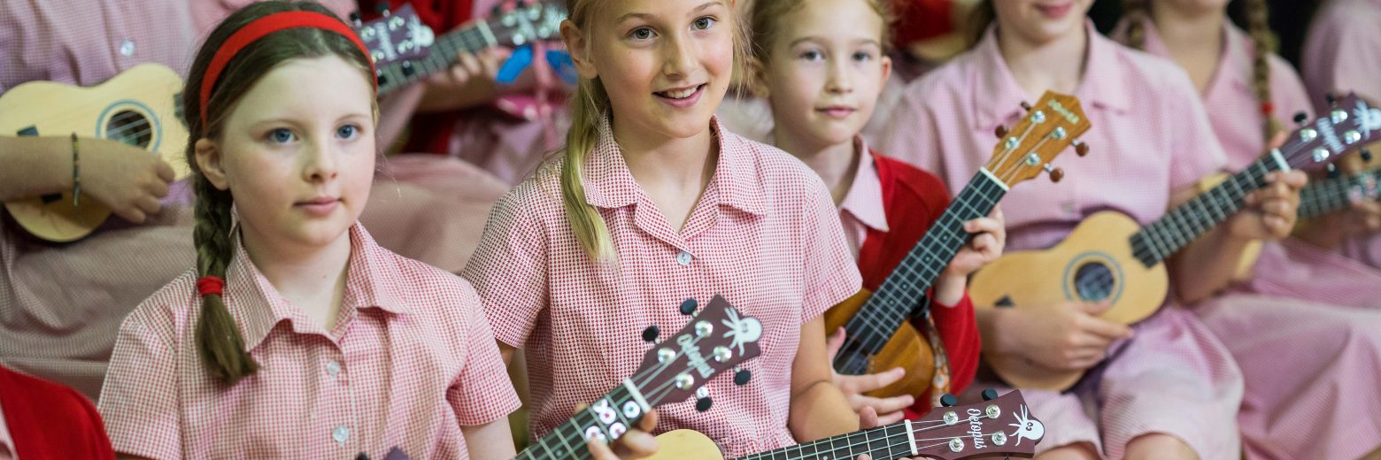 Students holding ukuleles