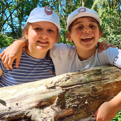 children holding a log