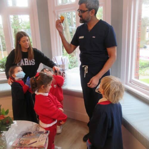 dentist showing toddlers his work