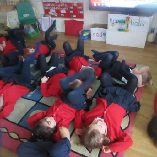 students rolling around on the floor
