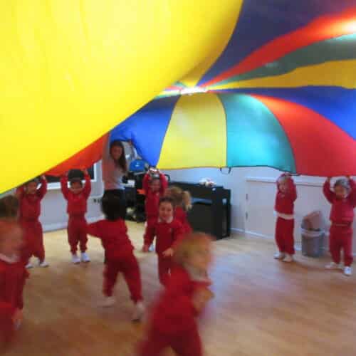 students under a parachute