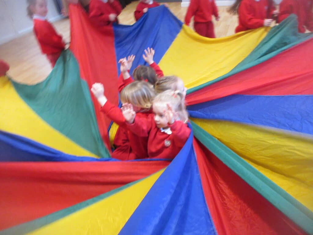 students inside a parachute