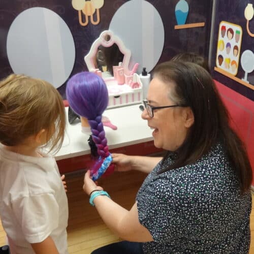 student and teacher braiding hair