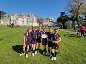 St Hilda's School U9 netball team showing off runners up certificates and medals after ISA Bee Netball Tournament